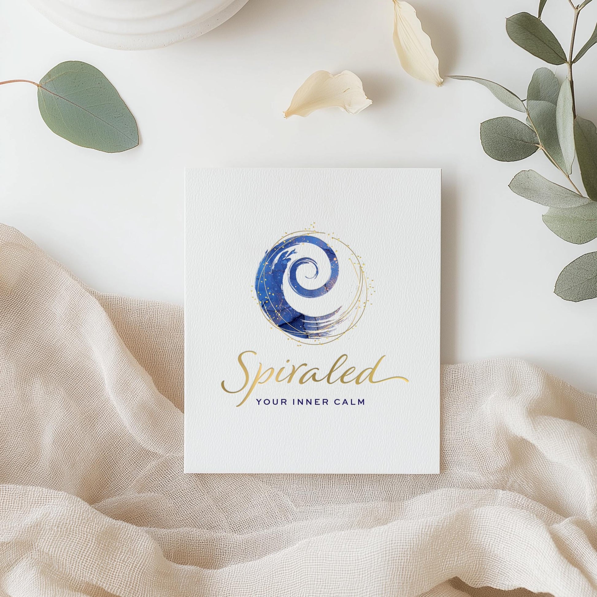 Customized Wellness Logo Design - Navy Blue Watercolor Spiral with Gold Script Font.  Branding Design for Health Clinic with luxury feel.
