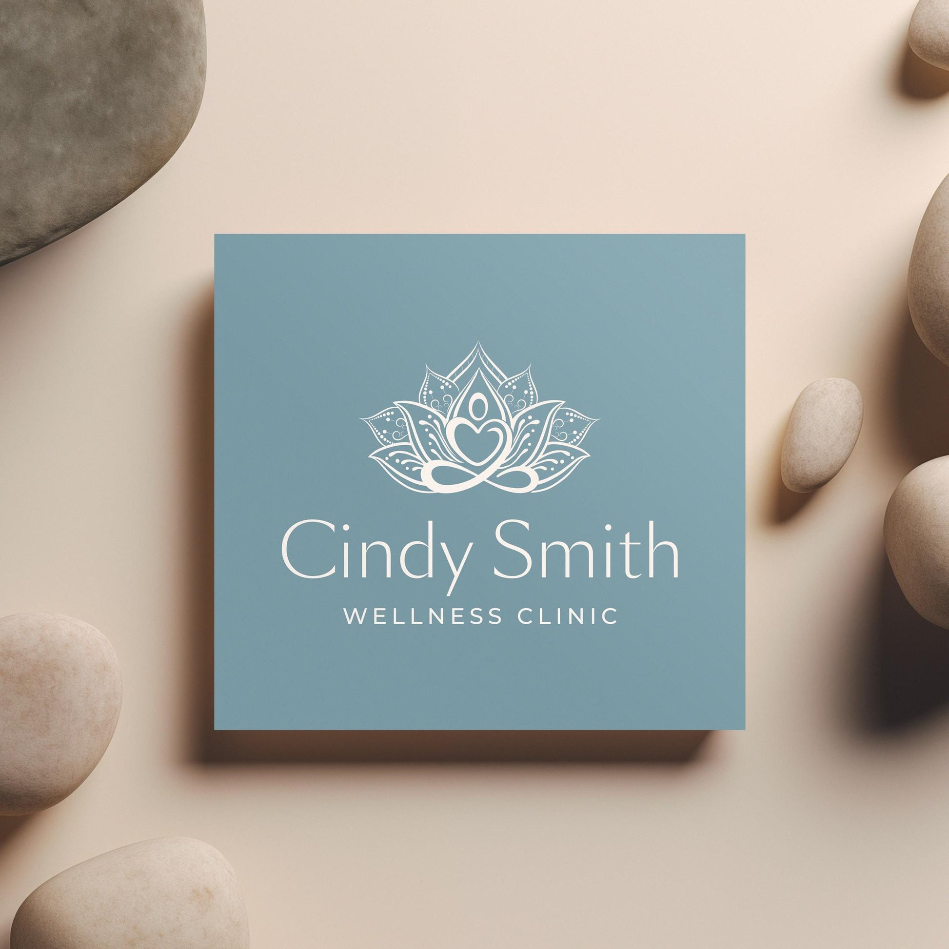 Image of a sophisticated wellness clinic logo featuring an elegant lotus design in gold on a deep teal blue background, perfect for high-end health, spa, and holistic therapy branding.